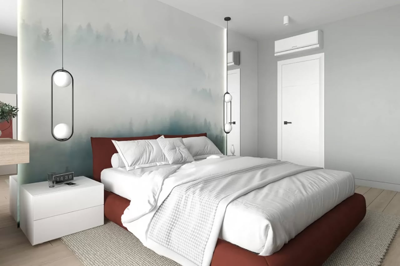 Спальня с кроватью, светлым интерьером, подвесными светильниками, стеной с лесным рисунком и современной мебелью