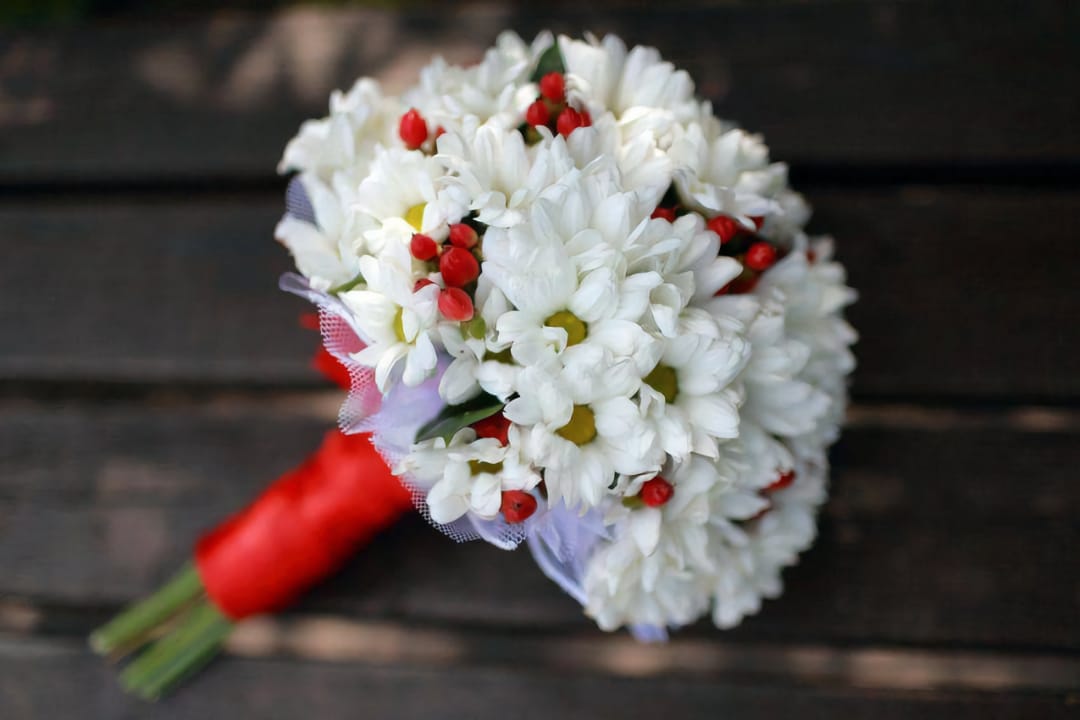 Букет нареченої з білі хризантеми з червоні ягоди, весілля, квітковий дизайн на дерев'яними тлі.